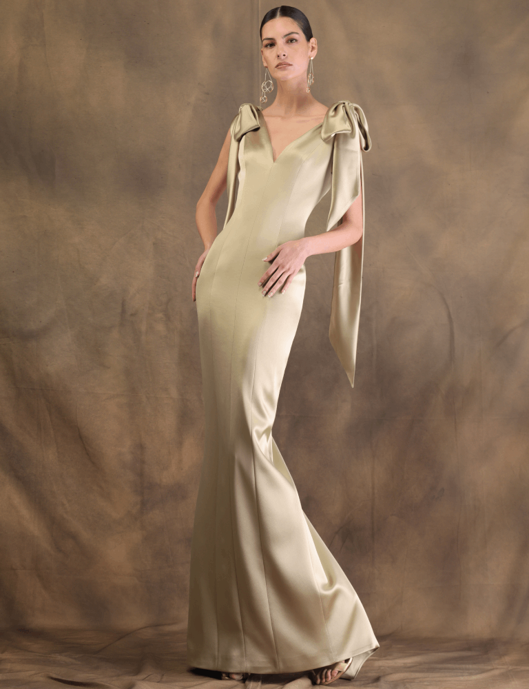 Gold Fely Campo evening gown with structured bows on the shoulders and a fitted silhouette