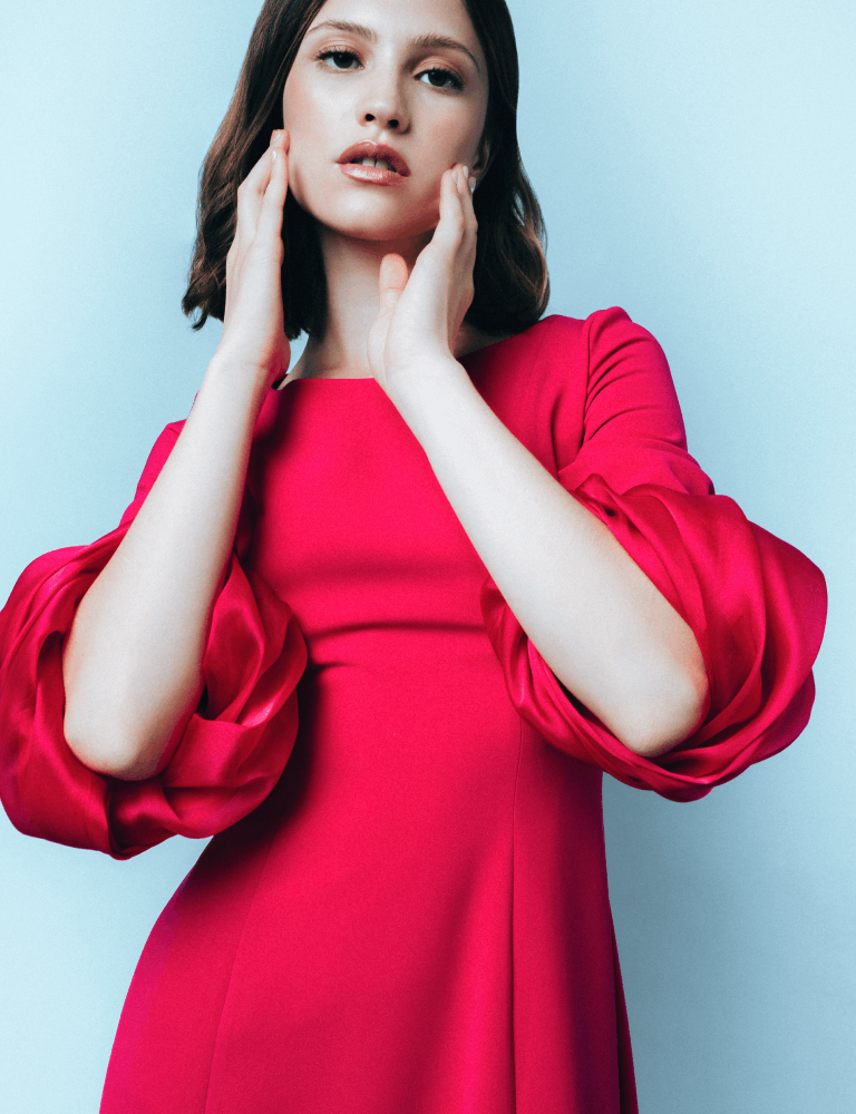 Red Fely Campo gown with puffed sleeves and high leg slit